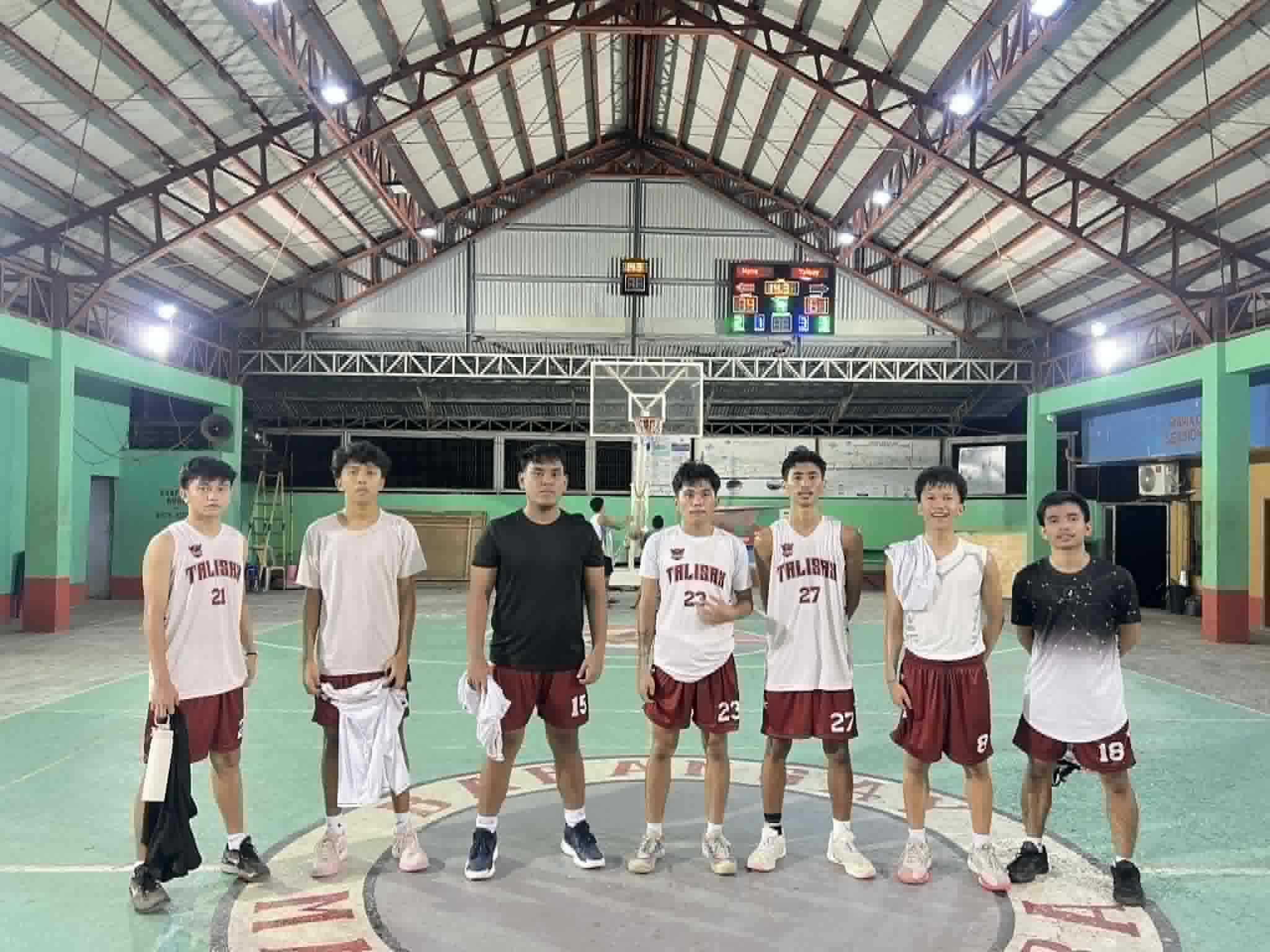 Group photo with basketball teammates on the court